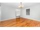 Hardwood floors and a chandelier enhance this simple yet elegant dining room at 1304 Park Ave, Dunn, NC 28334