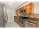A well-designed kitchen featuring stainless steel appliances and wooden cabinetry at 1304 Park Ave, Dunn, NC 28334