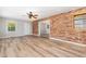 Bright living room with hardwood floors and a brick accent wall, blending character and modern style at 1304 Park Ave, Dunn, NC 28334