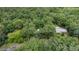 Secluded home nestled among lush trees offering privacy and a tranquil setting at 134 Chateau Rd, Durham, NC 27704