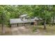 Elevated view of a home featuring a long driveway surrounded by lush greenery at 134 Chateau Rd, Durham, NC 27704