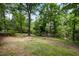 Spacious backyard with mature trees and lush lawn, perfect for outdoor activities at 134 Chateau Rd, Durham, NC 27704