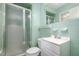 Vintage bathroom featuring classic tiles, shower with glass door, and a white vanity at 134 Chateau Rd, Durham, NC 27704