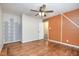 Cozy bedroom featuring unique wall accents, ceiling fan, and hardwood floors at 134 Chateau Rd, Durham, NC 27704