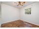 Bright bedroom with a window that offers outside views, ceiling fan, and hardwood floors at 134 Chateau Rd, Durham, NC 27704