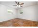 Empty bedroom features hardwood floors, two windows and white walls at 134 Chateau Rd, Durham, NC 27704