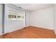 Bedroom with wood laminate flooring, bright window, and white walls at 134 Chateau Rd, Durham, NC 27704