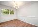 Bright dining room with wood floors, chair rail, and a modern chandelier at 134 Chateau Rd, Durham, NC 27704