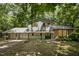 Two-story home with attached garage, and a yard surrounded by mature trees at 134 Chateau Rd, Durham, NC 27704