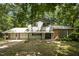 Two-story home with attached garage, and a yard surrounded by mature trees at 134 Chateau Rd, Durham, NC 27704