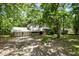 Two-story home with attached garage, and a yard surrounded by mature trees at 134 Chateau Rd, Durham, NC 27704