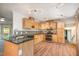 Well lit kitchen featuring natural wood cabinets, granite countertops, and stainless steel appliances at 134 Chateau Rd, Durham, NC 27704