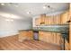 Kitchen with wood cabinets, granite countertops, modern appliances, and wood flooring at 134 Chateau Rd, Durham, NC 27704