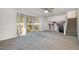 Spacious living room boasting large windows, a ceiling fan, and staircase access at 134 Chateau Rd, Durham, NC 27704