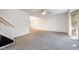 Inviting living room with plush carpeting, ceiling fan, and natural light at 134 Chateau Rd, Durham, NC 27704