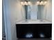 Bright bathroom with dual sinks, modern vanity, and spacious mirrors at 136 Bruce Dr Dr, Dunn, NC 28334