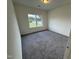 Cozy carpeted bedroom with a window overlooking the front lawn at 136 Bruce Dr Dr, Dunn, NC 28334