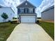 Charming two-story home with a two-car garage and a well-manicured lawn at 136 Bruce Dr Dr, Dunn, NC 28334