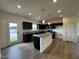 Open kitchen with granite counters, island, stainless appliances, and dark cabinetry at 136 Bruce Dr Dr, Dunn, NC 28334