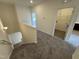 Carpeted staircase leading to the upper level with a view of the laundry room at 136 Bruce Dr Dr, Dunn, NC 28334