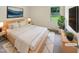 Comfortable bedroom with a bright window, neutral walls and modern furniture at 1413 Chamblee Rd, Zebulon, NC 27597