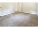 This bedroom features neutral carpeting, a door to hallway and an electrical outlet at 1413 Chamblee Rd, Zebulon, NC 27597