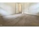 This bedroom features neutral carpeting and two closet doors providing ample storage space at 1413 Chamblee Rd, Zebulon, NC 27597