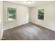 Cozy bedroom with neutral carpet, two windows letting in natural light creating a calm space at 1413 Chamblee Rd, Zebulon, NC 27597