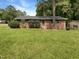 Charming brick ranch-style home featuring well-maintained lawn, shrubs, and a classic design at 1413 Chamblee Rd, Zebulon, NC 27597