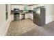 Modern kitchen with stainless steel appliances, white cabinets, and updated countertops at 1413 Chamblee Rd, Zebulon, NC 27597