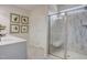 Bathroom boasts marble shower with a built-in seat, a white sink and artistic decor at 144 Bruce Dr, Dunn, NC 28334