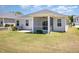 Backyard featuring a covered patio, green grass, and vinyl siding at 157 Willow Grove Ln, Fuquay Varina, NC 27526