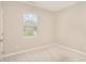This is a simple bedroom with beige walls, carpet, and a window at 157 Willow Grove Ln, Fuquay Varina, NC 27526