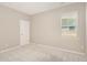 This is a simple bedroom with beige walls, carpet, and a window at 157 Willow Grove Ln, Fuquay Varina, NC 27526