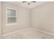 Neutral bedroom with carpet, ceiling fan, and large window at 157 Willow Grove Ln, Fuquay Varina, NC 27526