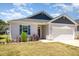 Charming single-story home with a two-car garage, and well-manicured lawn at 157 Willow Grove Ln, Fuquay Varina, NC 27526
