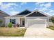 Charming single-story home with a two-car garage, and well-manicured lawn at 157 Willow Grove Ln, Fuquay Varina, NC 27526