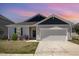 Charming home with a two-car garage, well-maintained lawn, and lovely landscaping at 157 Willow Grove Ln, Fuquay Varina, NC 27526