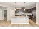 Modern kitchen with stainless steel appliances, center island, and granite countertops at 157 Willow Grove Ln, Fuquay Varina, NC 27526