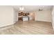 Open-concept living space with wood-look floors adjacent to the kitchen at 157 Willow Grove Ln, Fuquay Varina, NC 27526