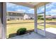 View from the screened patio shows a lush backyard and neighboring houses at 157 Willow Grove Ln, Fuquay Varina, NC 27526