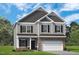Charming two-story home featuring gray siding, stone accents, and a well-manicured lawn at 16 Freedom Heights Ln, Smithfield, NC 27577