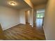 Bright living area with modern wood flooring and an open doorway into another room at 16 Freedom Heights Ln, Smithfield, NC 27577