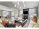Bright living room featuring a fireplace, modern lighting, open floor plan, and seamless access to the dining area at 16 W Currituck Cir, Garner, NC 27529
