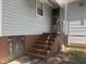 Home's back entrance with brick steps, handrail and basement access at 1704 Southgate St, Durham, NC 27703