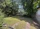 Large backyard surrounded by mature trees with lush greenery at 1704 Southgate St, Durham, NC 27703