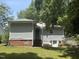 View of the side and back of the house showing the back entry and side basement entry at 1704 Southgate St, Durham, NC 27703