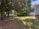 Lush backyard with mature trees, partial fence and grassy lawn at 1704 Southgate St, Durham, NC 27703
