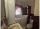 This bathroom has a shower tub combo, a mirror, sink and red colored tiling at 1704 Southgate St, Durham, NC 27703