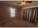 Bedroom featuring carpeted flooring, neutral color scheme, window for natural light and ceiling fan at 1704 Southgate St, Durham, NC 27703